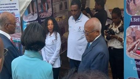 Officials being shown the market-based sanitation stand at the award event