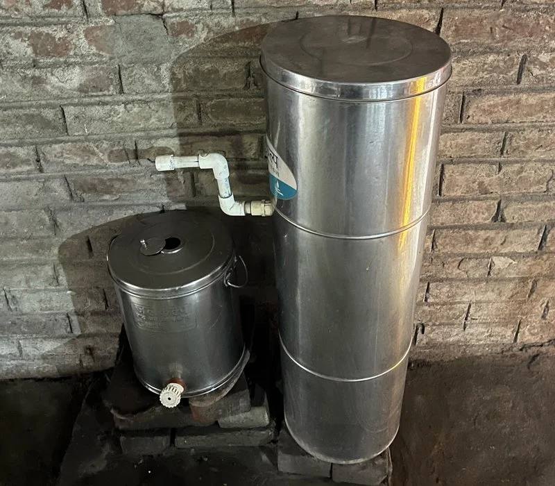 A stainless-steel biosand filter installed in a home in Bihar, India