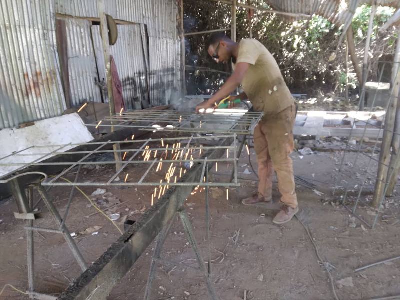 A fabricator welding a steel panel mold