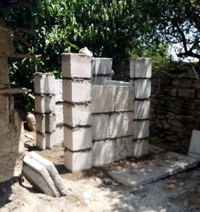 Trial assembly of a toilet superstructure from interlocking precast panels and corner joints